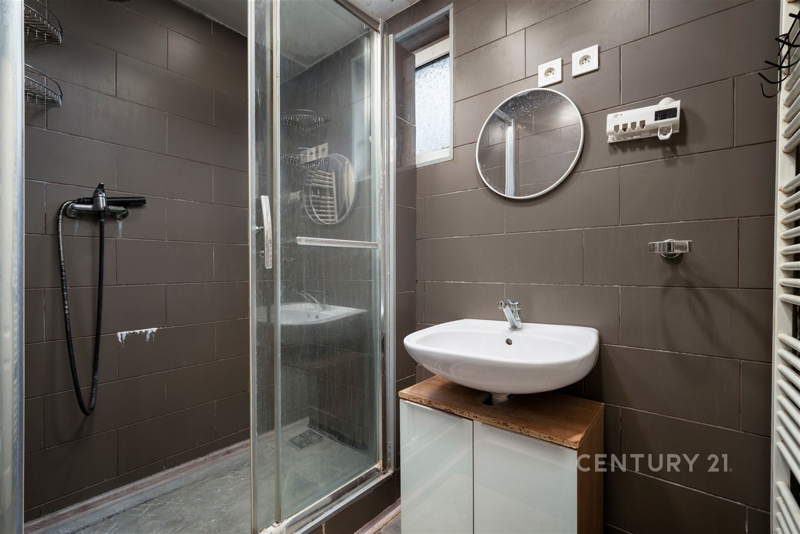 Moderní koupelna s tmavou dlažbou, sprchovým koute