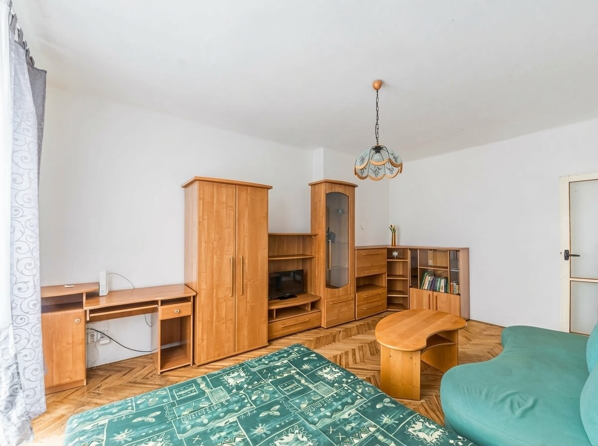 Útulný obývák se sedačkou, skříňovou stěnou a post