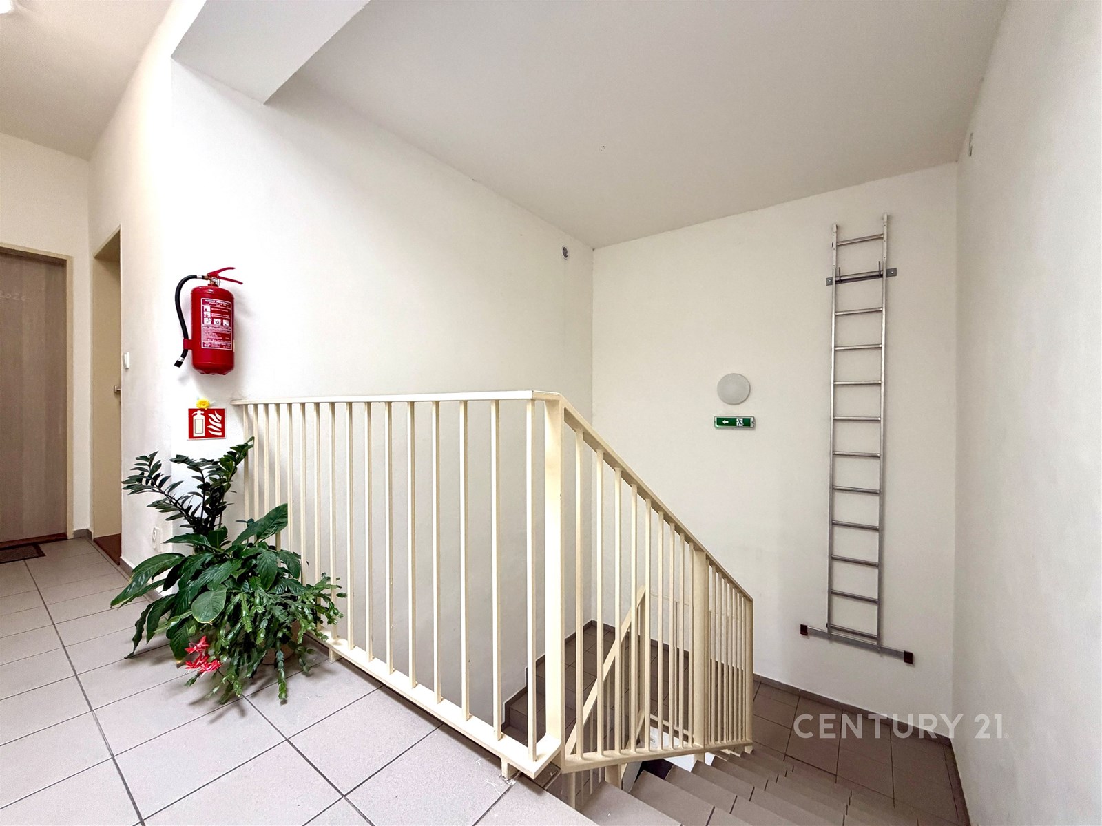 Chodba se schodištěm, světlá výmalba, keramická dl