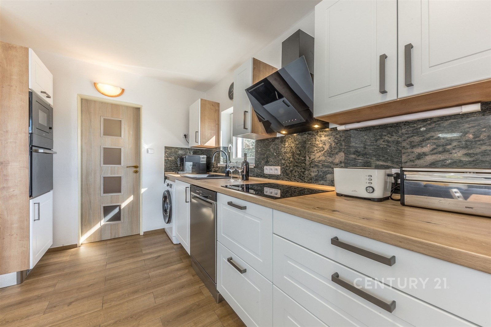 Moderní kuchyň s parketovou podlahou, vestavěnými 