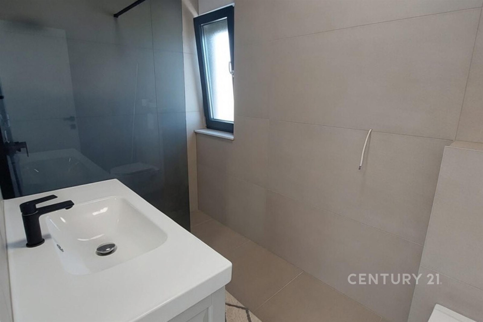 Koupelna s moderními dlaždicemi, sprchovým koutem 