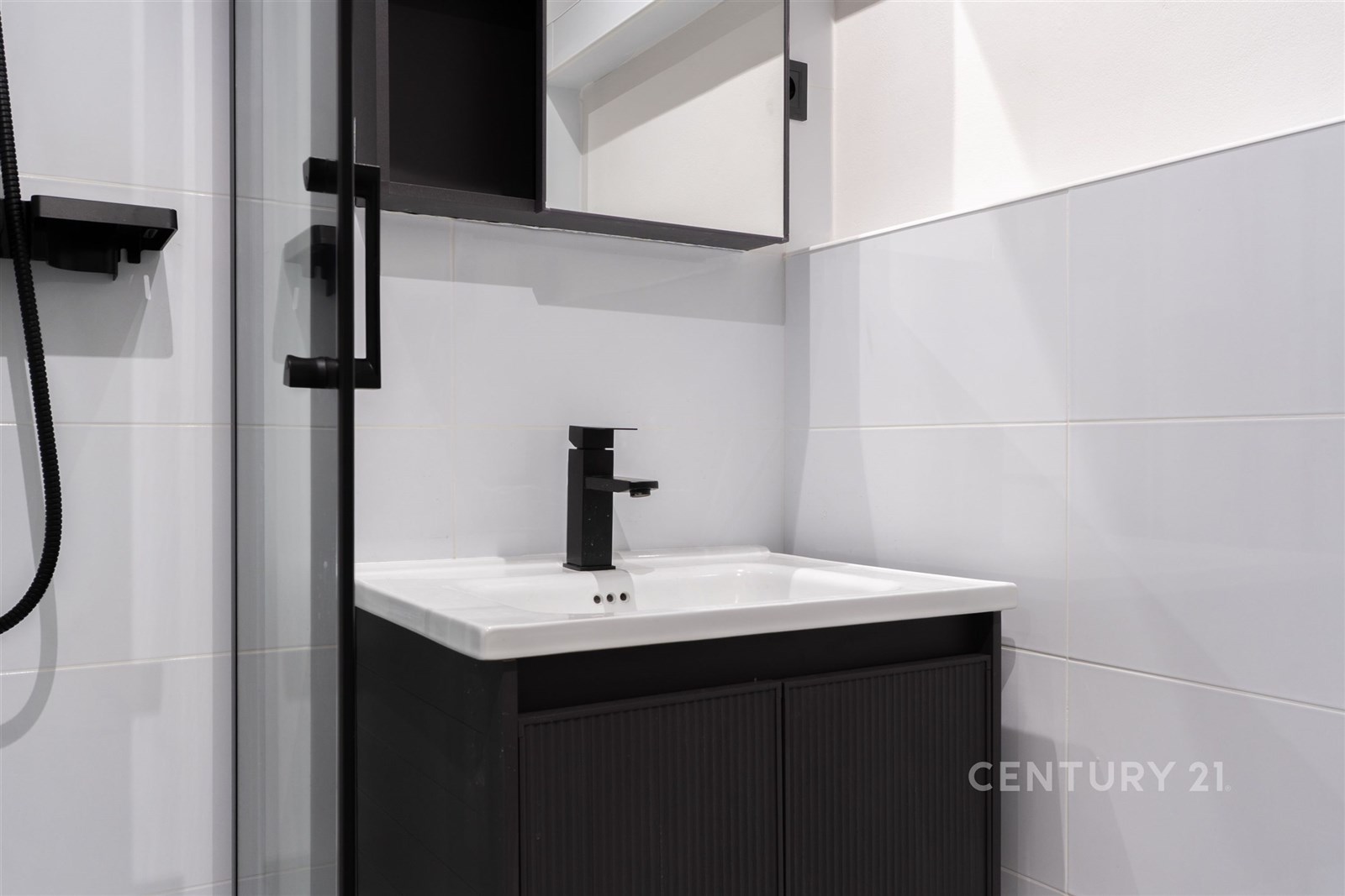 Moderní koupelna s černými doplňky, elegantní dlaž