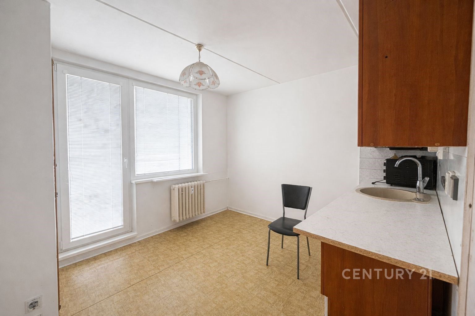 Světlá kuchyň s laminátovou podlahou, velkými okny