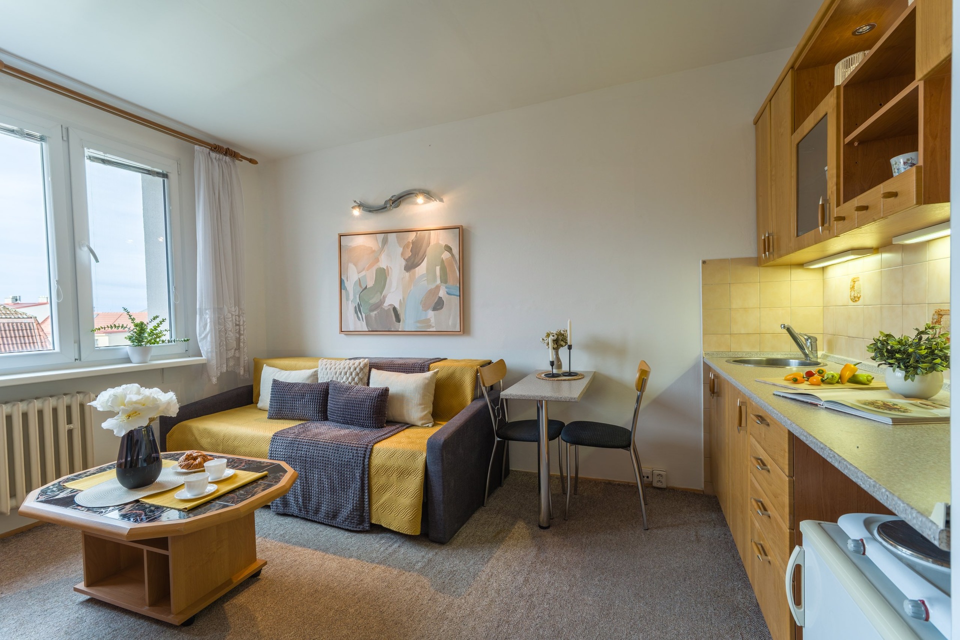 Obývací pokoj s kuchyňskou linkou vpravo